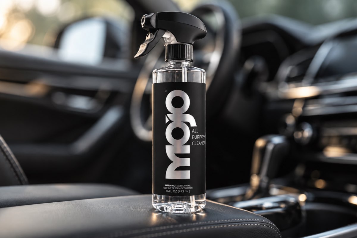 The MOJO bottle on the leather console inside a car.