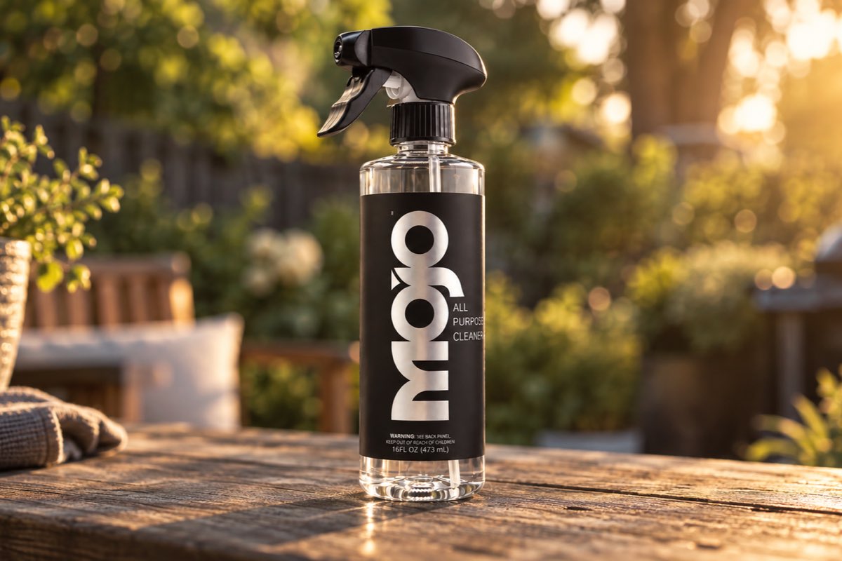 The MOJO bottle on a wooden patio table in evening light.